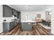 Modern kitchen featuring gray cabinetry, stainless steel appliances, a large island, and hardwood flooring at 2117 Broadway St, Indianapolis, IN 46202