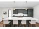 Stunning kitchen features a spacious island with seating, pendant lighting, and sleek gray cabinetry at 2117 Broadway St, Indianapolis, IN 46202