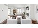 Open-concept living room with fireplace, modern furniture, hardwood floors, and a view of the entryway at 2117 Broadway St, Indianapolis, IN 46202