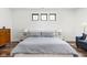 Tranquil bedroom featuring a comfortable bed, side tables with lamps, and a hardwood floor at 2117 Broadway St, Indianapolis, IN 46202