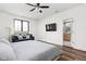Bright main bedroom with a ceiling fan, wood floors, and a comfortable sitting area by the window at 2117 Broadway St, Indianapolis, IN 46202