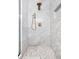 Luxurious shower with white marble-look tile, brass fixtures, and a decorative tiled accent wall at 2117 Broadway St, Indianapolis, IN 46202