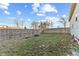Large backyard area with a wooden fence, some trees, and space for outdoor activities at 2243 E Werges Ave, Indianapolis, IN 46237