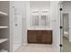 A bright bathroom features double sinks, a shower, and modern fixtures, showcasing its practical elegance at 2243 E Werges Ave, Indianapolis, IN 46237
