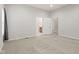 Bright bedroom features neutral walls, carpet, and a view into the ensuite bathroom, offering a serene and comfortable space at 2243 E Werges Ave, Indianapolis, IN 46237