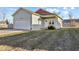 View of a single-Gathering home with an attached garage, front yard, and sunny skies at 2243 E Werges Ave, Indianapolis, IN 46237