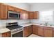 Gourmet kitchen featuring stainless steel appliances, stone countertops, and custom cabinetry at 2243 E Werges Ave, Indianapolis, IN 46237
