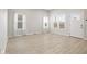 Inviting living room with light wood flooring, windows, and white trim throughout at 2243 E Werges Ave, Indianapolis, IN 46237