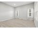 Bright living room with neutral walls, light wood flooring, and natural light from the windows at 2243 E Werges Ave, Indianapolis, IN 46237