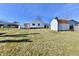 Spacious backyard featuring a shed, a black chain link fence, and a deck for outdoor entertaining at 2521 Beechcrest Dr, Indianapolis, IN 46203