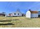 Backyard featuring a white house, deck, shed, and a large grassy yard at 2521 Beechcrest Dr, Indianapolis, IN 46203