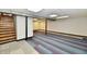 Finished basement features stairway, carpeted area, support beam and potential for customization at 2521 Beechcrest Dr, Indianapolis, IN 46203