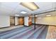 Finished basement with drop ceiling, support beams, and colorful carpet squares at 2521 Beechcrest Dr, Indianapolis, IN 46203