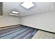 Unfinished basement featuring unique multi-patterned flooring and a drop ceiling with recessed lighting at 2521 Beechcrest Dr, Indianapolis, IN 46203