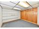 Unfinished basement with drop ceiling, built-in shelving, and neutral carpeting at 2521 Beechcrest Dr, Indianapolis, IN 46203