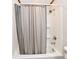 Shower and tub combo with grey shower curtain at 2521 Beechcrest Dr, Indianapolis, IN 46203
