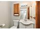 Neutral half bath features a vanity sink, cabinet, mirror, toilet, and light fixture at 2521 Beechcrest Dr, Indianapolis, IN 46203