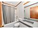 Bathroom features a bathtub with shower and curtain, toilet and vanity with grey sink at 2521 Beechcrest Dr, Indianapolis, IN 46203