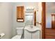 Neutral half bath features a vanity sink, cabinet, mirror, toilet, and light fixture at 2521 Beechcrest Dr, Indianapolis, IN 46203