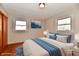 Comfortable bedroom with hardwood floors, natural light, and calming blue accents at 2521 Beechcrest Dr, Indianapolis, IN 46203