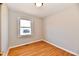 Bright bedroom features hardwood floors, baseboards, and a window at 2521 Beechcrest Dr, Indianapolis, IN 46203