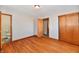 Bedroom with hardwood floors, closet, doors, and view to an attached bathroom at 2521 Beechcrest Dr, Indianapolis, IN 46203