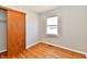 Bedroom features hardwood floors, a closet with sliding doors, and a window at 2521 Beechcrest Dr, Indianapolis, IN 46203