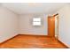 Bedroom with hardwood flooring, window, and door to ensuite bathroom at 2521 Beechcrest Dr, Indianapolis, IN 46203