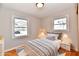 Cozy bedroom featuring hardwood floors, neutral decor, and a comfortable bed at 2521 Beechcrest Dr, Indianapolis, IN 46203