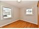 Clean bedroom with hardwood floors and natural light from two windows at 2521 Beechcrest Dr, Indianapolis, IN 46203