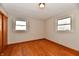 Bedroom with hardwood floors, two windows, closet and light fixture at 2521 Beechcrest Dr, Indianapolis, IN 46203