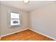 Bright bedroom features hardwood floors, baseboards, and a window at 2521 Beechcrest Dr, Indianapolis, IN 46203