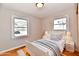 Cozy bedroom featuring hardwood floors, neutral decor, and a comfortable bed at 2521 Beechcrest Dr, Indianapolis, IN 46203