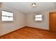 Bedroom featuring hardwood floors, neutral walls, and natural light from two windows at 2521 Beechcrest Dr, Indianapolis, IN 46203