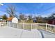 A white deck overlooks the backyard and features a white railing and a view of the neighborhood at 2521 Beechcrest Dr, Indianapolis, IN 46203