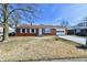 Charming brick ranch home featuring white trim, an attached garage and a well manicured front yard at 2521 Beechcrest Dr, Indianapolis, IN 46203