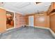Spacious garage features speckled flooring, wood paneling, and built-in shelving for ample storage space at 2521 Beechcrest Dr, Indianapolis, IN 46203