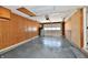 An empty garage featuring painted walls, a painted floor, and a white garage door at 2521 Beechcrest Dr, Indianapolis, IN 46203