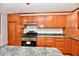 Well-lit kitchen features wood cabinets, stainless steel oven, marble countertops, and tile backsplash at 2521 Beechcrest Dr, Indianapolis, IN 46203