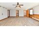 Large living room with wood-look floors and multiple doorways and windows at 2521 Beechcrest Dr, Indianapolis, IN 46203