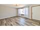 Bright living room with large window, laminate floor, and neutral paint at 2521 Beechcrest Dr, Indianapolis, IN 46203