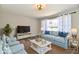 Bright living room with a large window, wood floors, and comfortable seating arrangement at 2521 Beechcrest Dr, Indianapolis, IN 46203