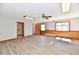 Spacious living room with wood-look floors, two windows, and multiple doorways at 2521 Beechcrest Dr, Indianapolis, IN 46203