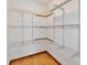 Walk-in closet with custom metal shelving and hardwood floors at 2521 Beechcrest Dr, Indianapolis, IN 46203