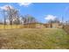 Expansive backyard featuring a sturdy wood fence and storage shed offering ample space and privacy at 305 Bixler Rd, Indianapolis, IN 46227