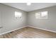 Bright bedroom featuring wood-look floors, neutral walls, and natural light from the windows at 305 Bixler Rd, Indianapolis, IN 46227