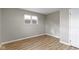 Empty bedroom with wood-look flooring, a window providing natural light, and neutral walls at 305 Bixler Rd, Indianapolis, IN 46227