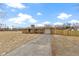 Charming single-story brick home with a paved drive and fenced yard at 305 Bixler Rd, Indianapolis, IN 46227