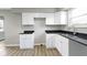 White cabinets and black countertops create a stylish look in the kitchen at 305 Bixler Rd, Indianapolis, IN 46227