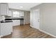Bright kitchen features white cabinets, black countertops, and modern wood flooring at 305 Bixler Rd, Indianapolis, IN 46227
